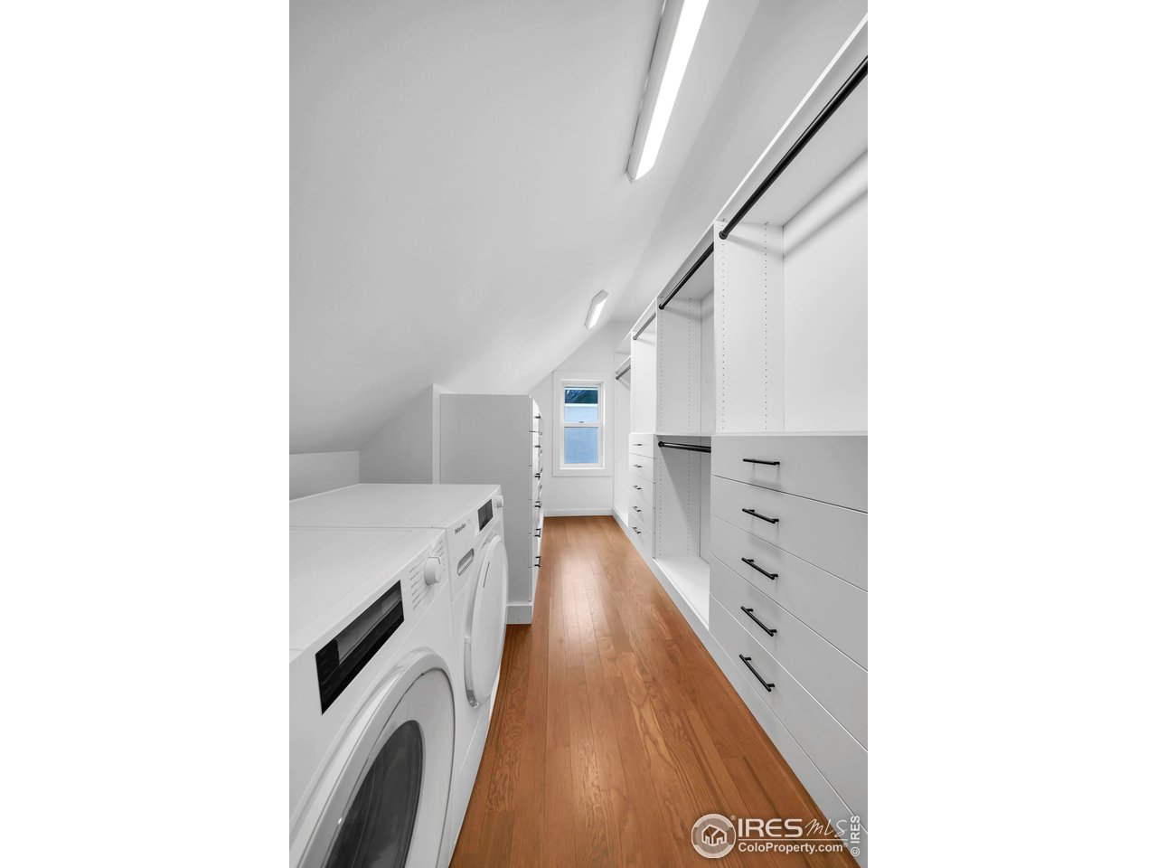 1627 17th Street Boulder, CO 80302 - Photo 21 of 44 Primary Walk In closet with built in shelving and Washer and Dryer