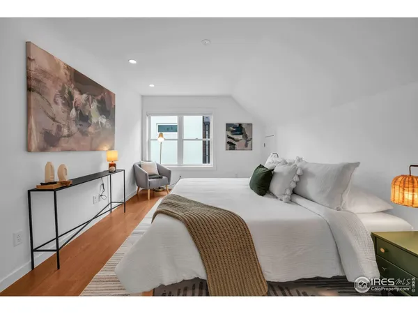 a bedroom with a bed and glass windows