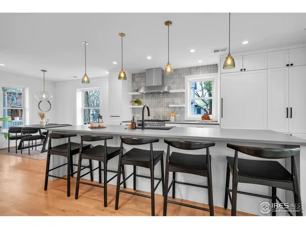a kitchen with a table chairs stove and cabinets