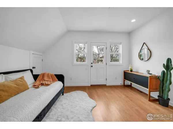 a bedroom with furniture and a window