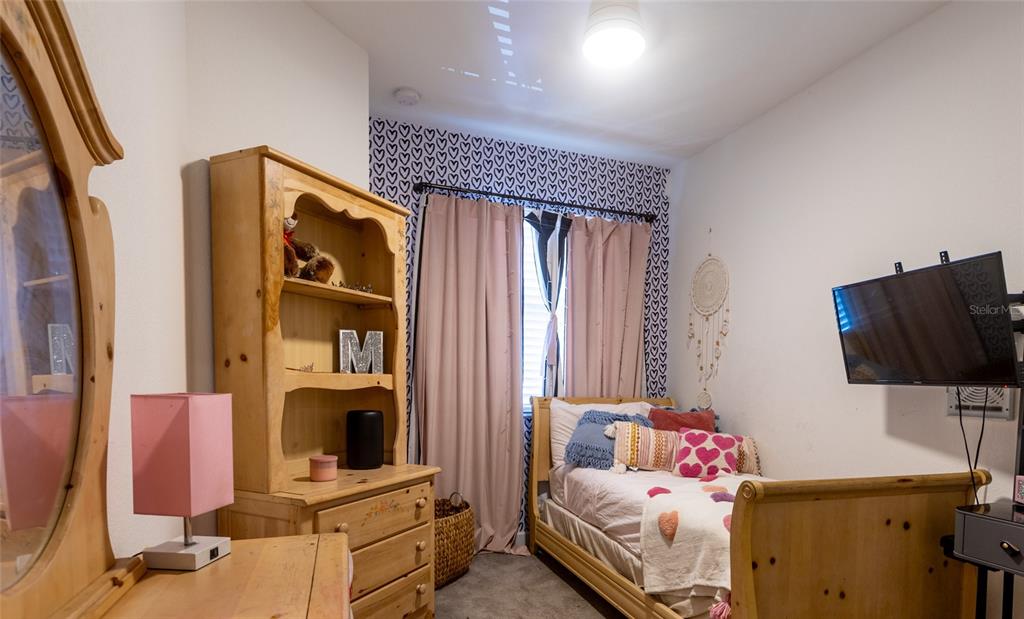 25190 Southwest 107th Avenue Homestead, FL 33032 - Photo 12 of 57 a bedroom with a bed and flat tv screen on the dresser