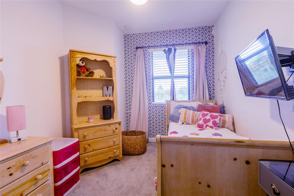 25190 Southwest 107th Avenue Homestead, FL 33032 - Photo 14 of 57 a bedroom with a bed and a window