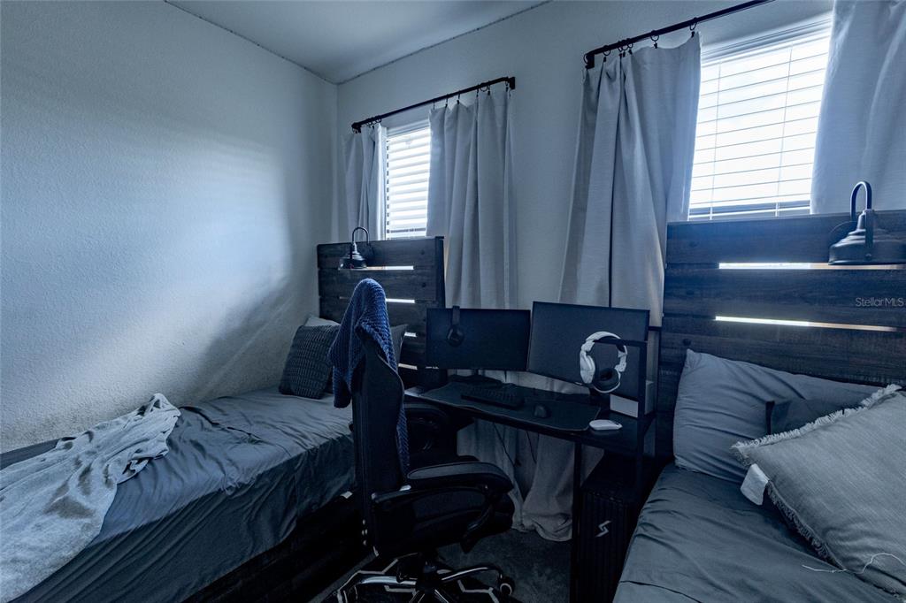 25190 Southwest 107th Avenue Homestead, FL 33032 - Photo 20 of 57 a bedroom with a bed and wooden floor