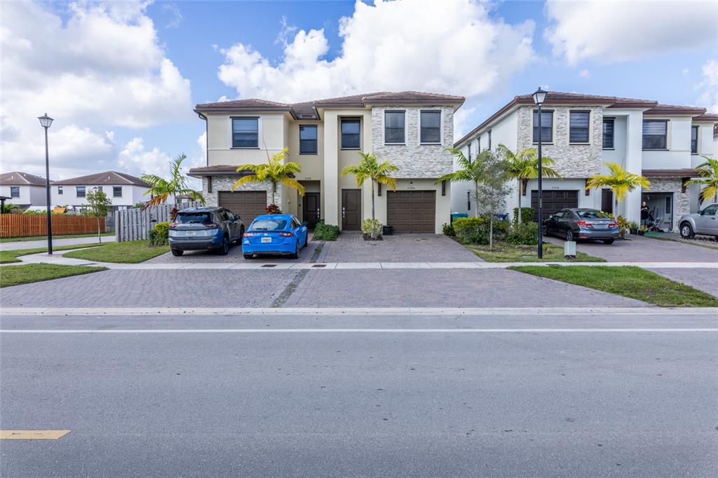 25190 Southwest 107th Avenue Homestead, FL 33032 - Photo 2 of 57 a view of street with parked cars