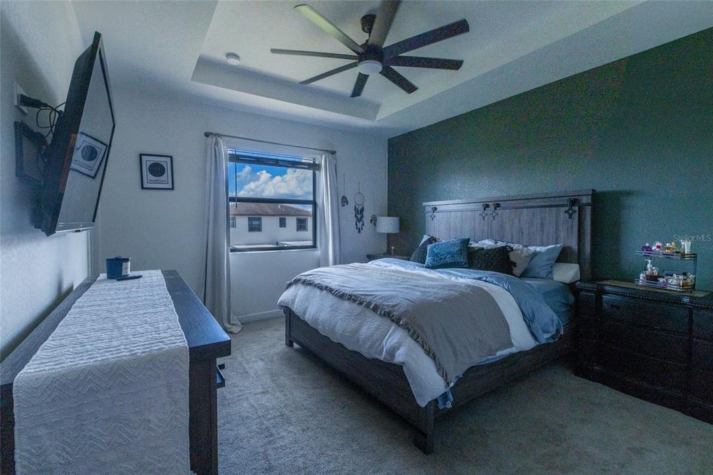 25190 Southwest 107th Avenue Homestead, FL 33032 - Photo 31 of 57 a bedroom with a bed and a flat screen tv