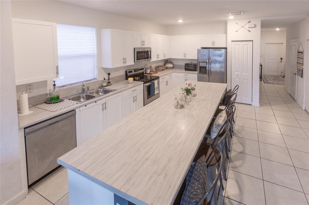 25190 Southwest 107th Avenue Homestead, FL 33032 - Photo 42 of 57 a large kitchen with a large counter top appliances and cabinets