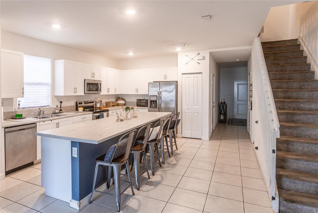 25190 Southwest 107th Avenue Homestead, FL 33032 - Photo 43 of 57 a kitchen with a sink a counter top space cabinets and stainless steel appliances