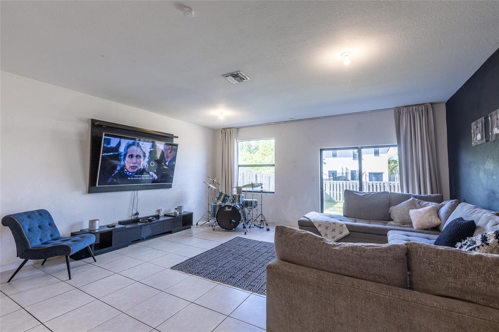 25190 Southwest 107th Avenue Homestead, FL 33032 - Photo 48 of 57 a living room with furniture and a flat screen tv
