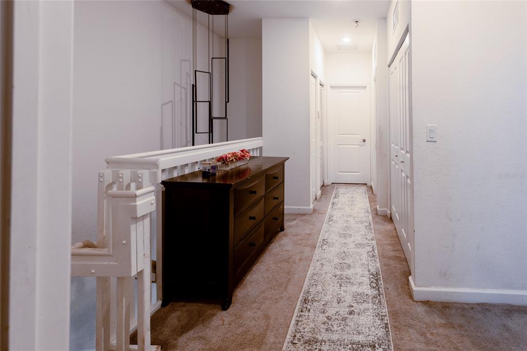 25190 Southwest 107th Avenue Homestead, FL 33032 - Photo 10 of 57 a hallway with a sink and a mirror