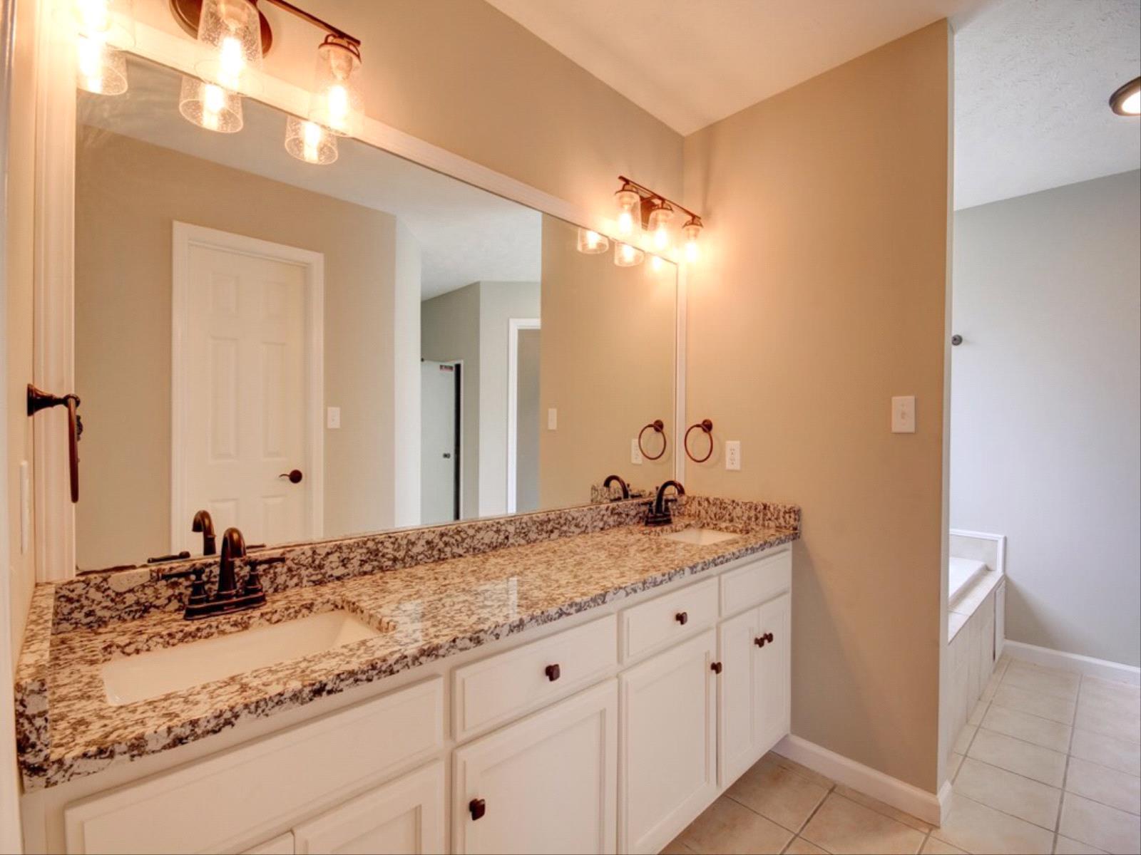 3587 Rabbit Run Trail Clarksville, TN 37043 - Photo 15 of 30 a bathroom with a granite countertop sink and a mirror