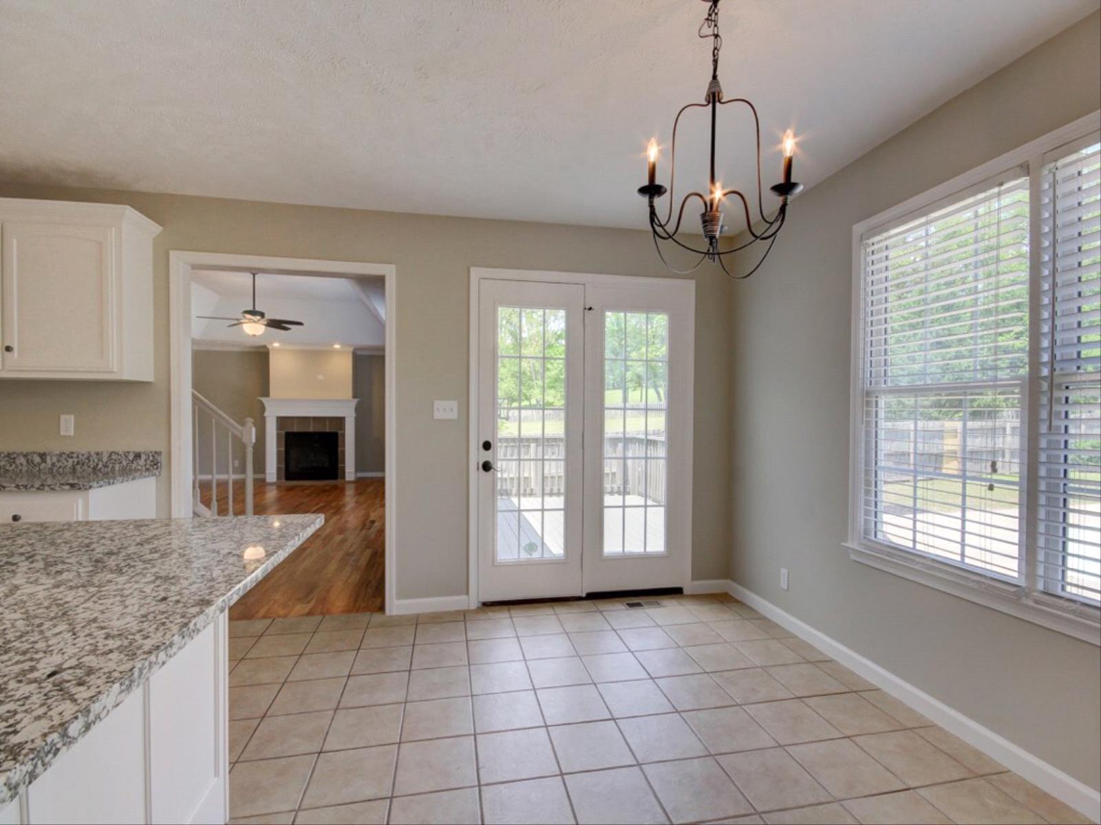 3587 Rabbit Run Trail Clarksville, TN 37043 - Photo 6 of 30 a view of a kitchen with granite countertop cabinets a dining table and a chandelier
