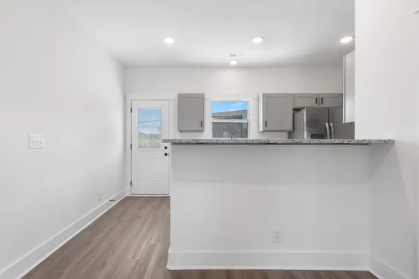 a view of a kitchen with center island and stainless steel appliances