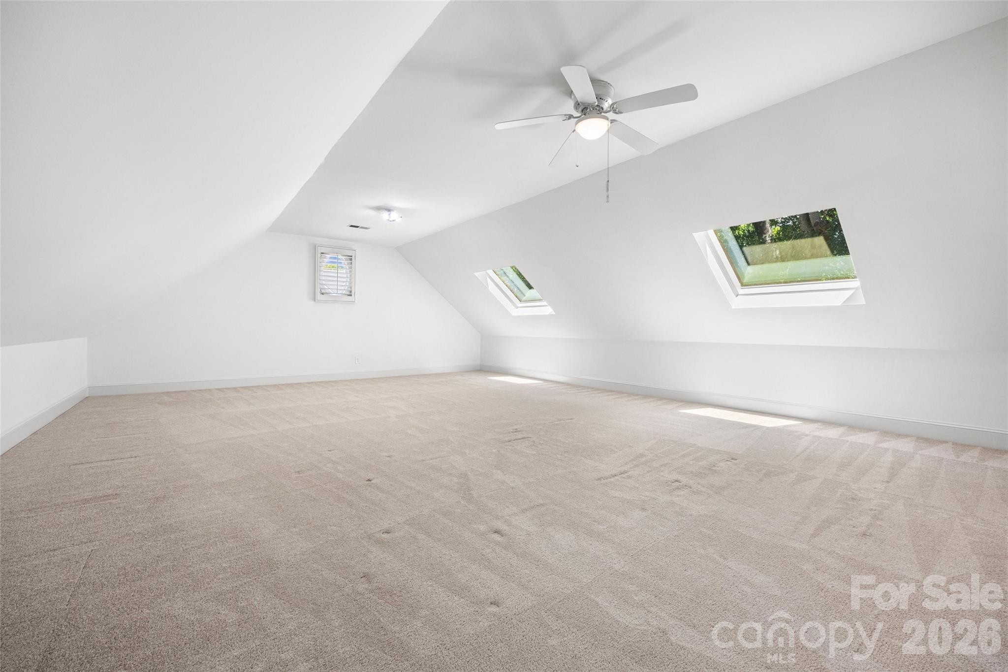 636 Landsdowne Court Fort Mill, SC 29708 - Photo 29 of 48 an empty room with a window and a ceiling fan