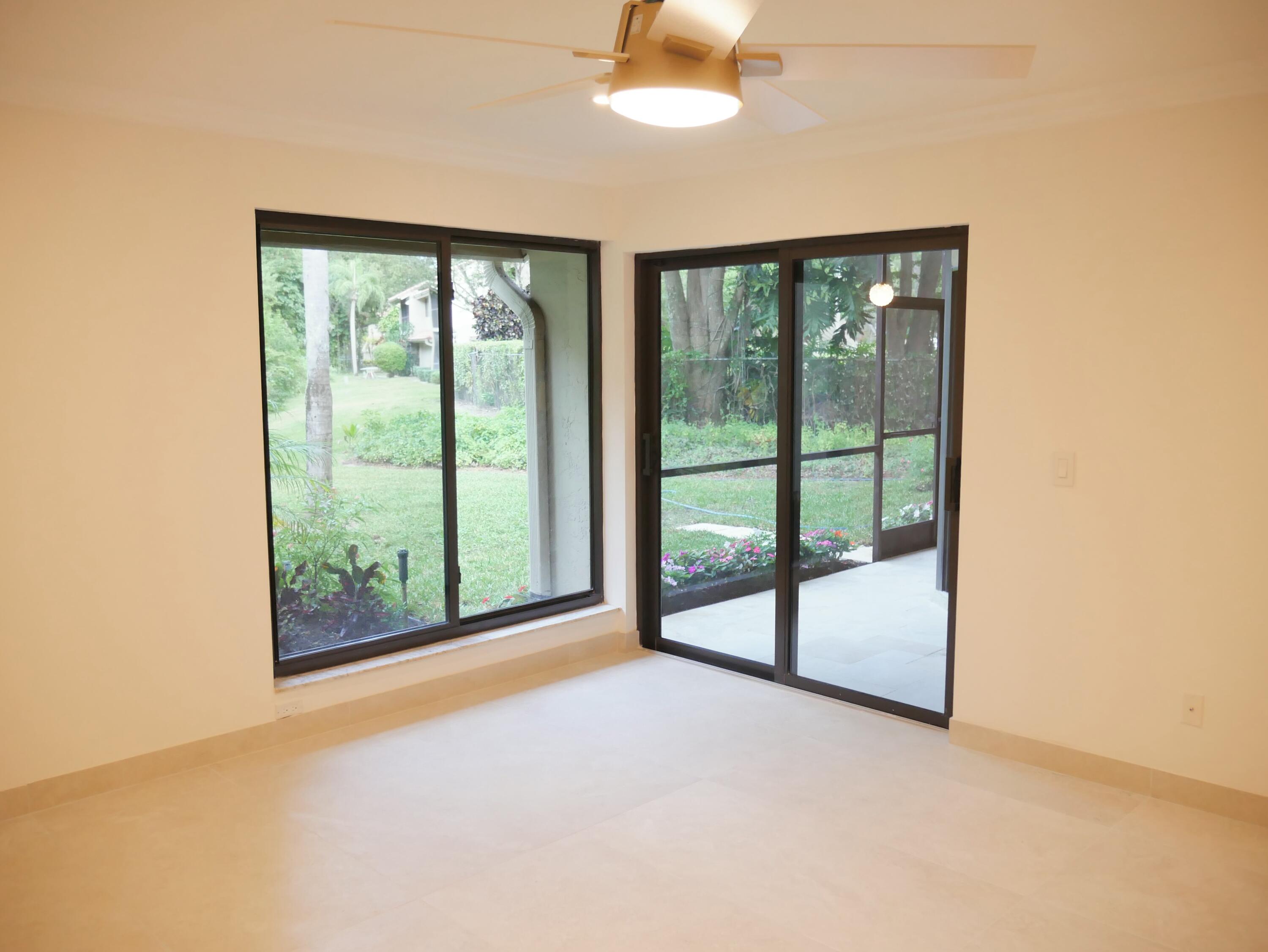 5630 Coach House Circle, Unit D Boca Raton, FL 33486 - Photo 11 of 26 an empty room with windows and city view