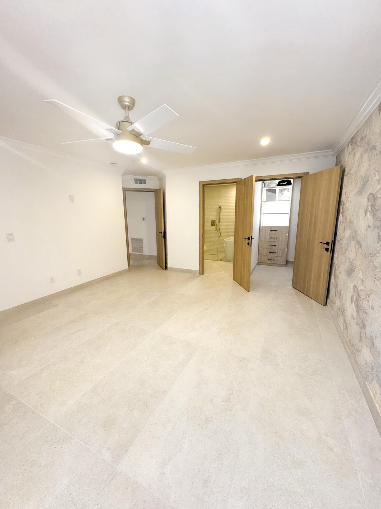 5630 Coach House Circle, Unit D Boca Raton, FL 33486 - Photo 13 of 26 an empty room with closet and windows