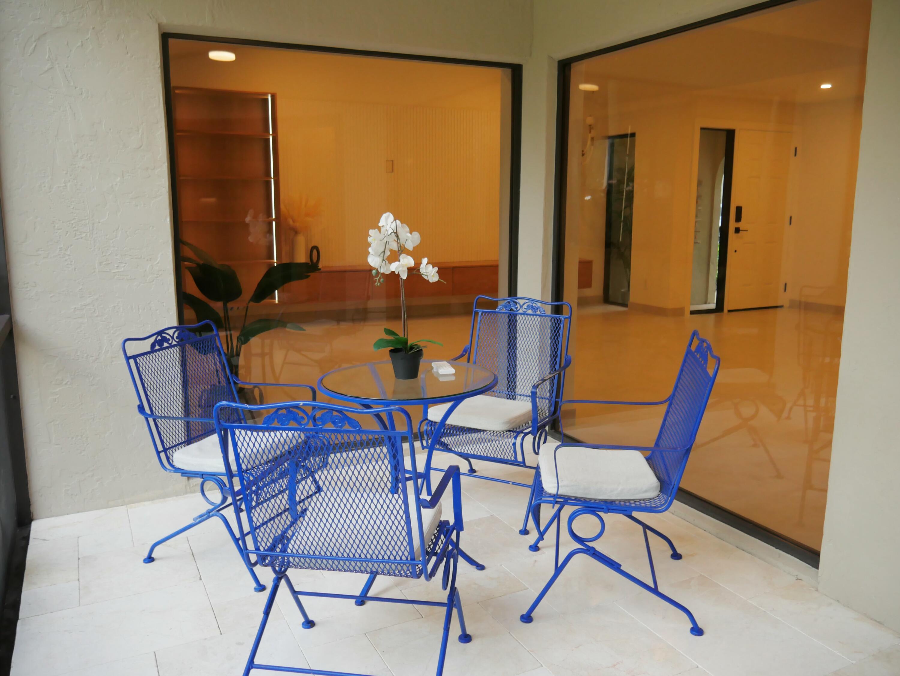 5630 Coach House Circle, Unit D Boca Raton, FL 33486 - Photo 24 of 26 a view of a dining room with furniture and chandelier