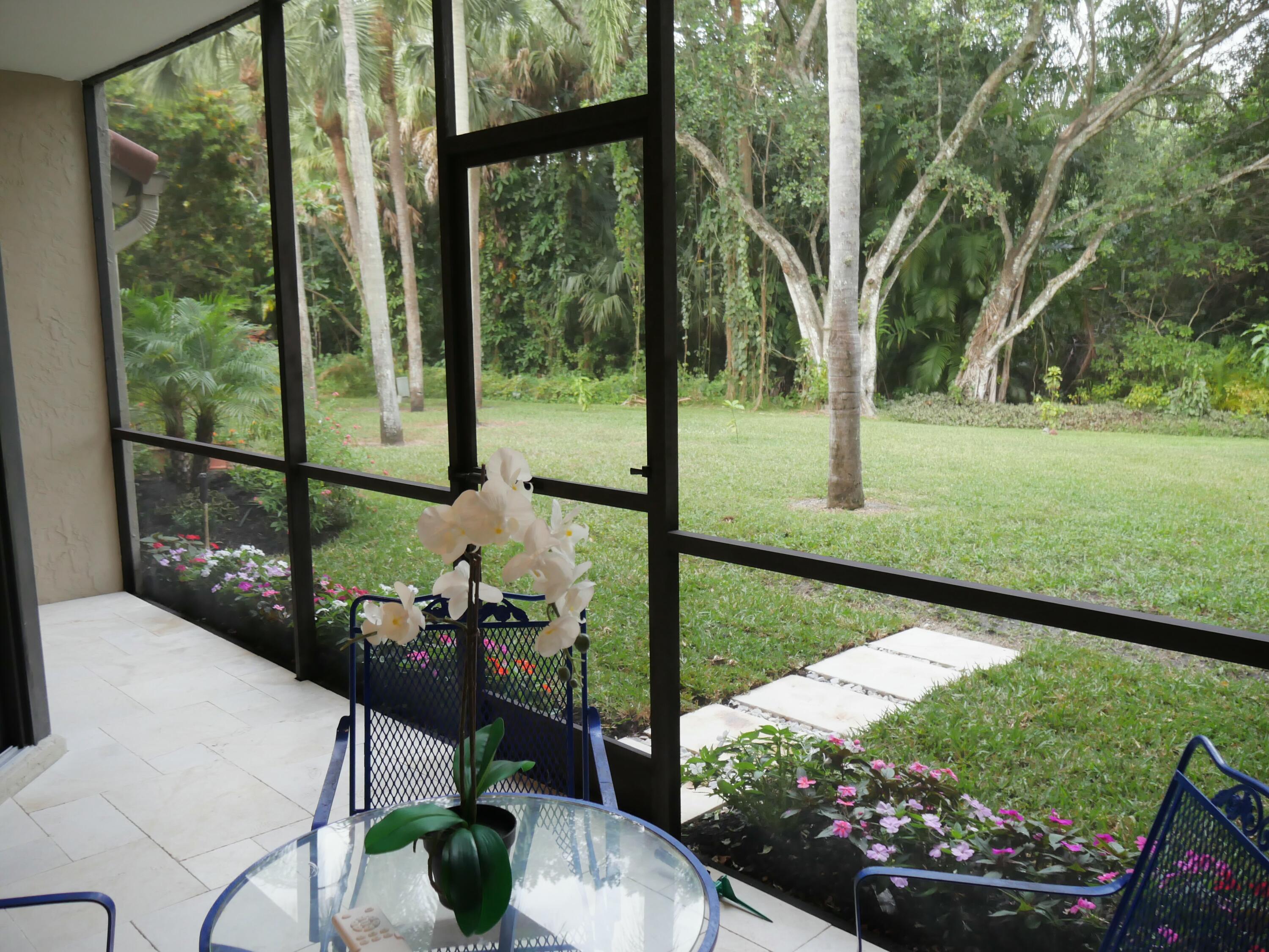 5630 Coach House Circle, Unit D Boca Raton, FL 33486 - Photo 25 of 26 a view of a porch with furniture and garden