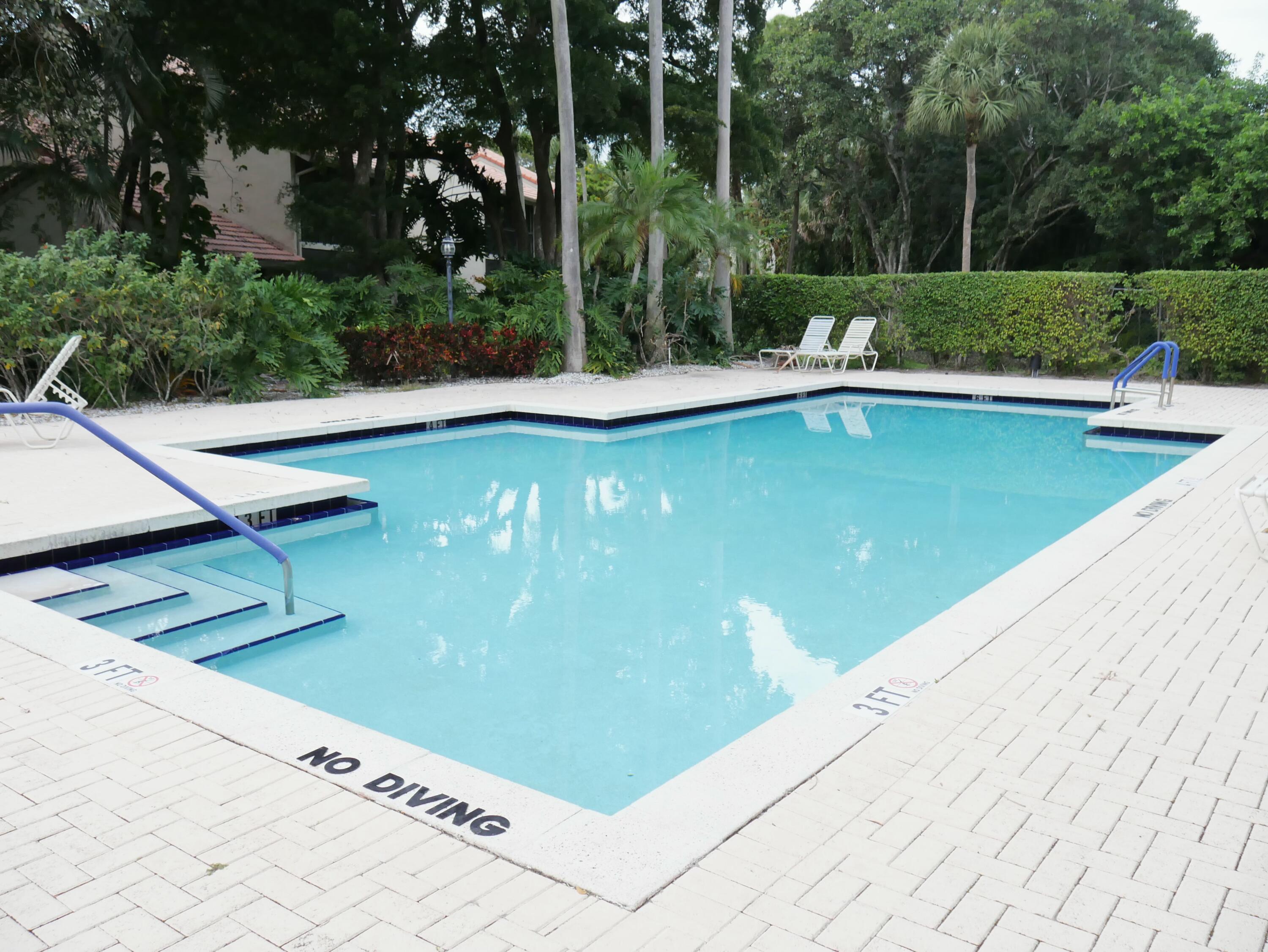 5630 Coach House Circle, Unit D Boca Raton, FL 33486 - Photo 26 of 26 a view of a swimming pool with a patio