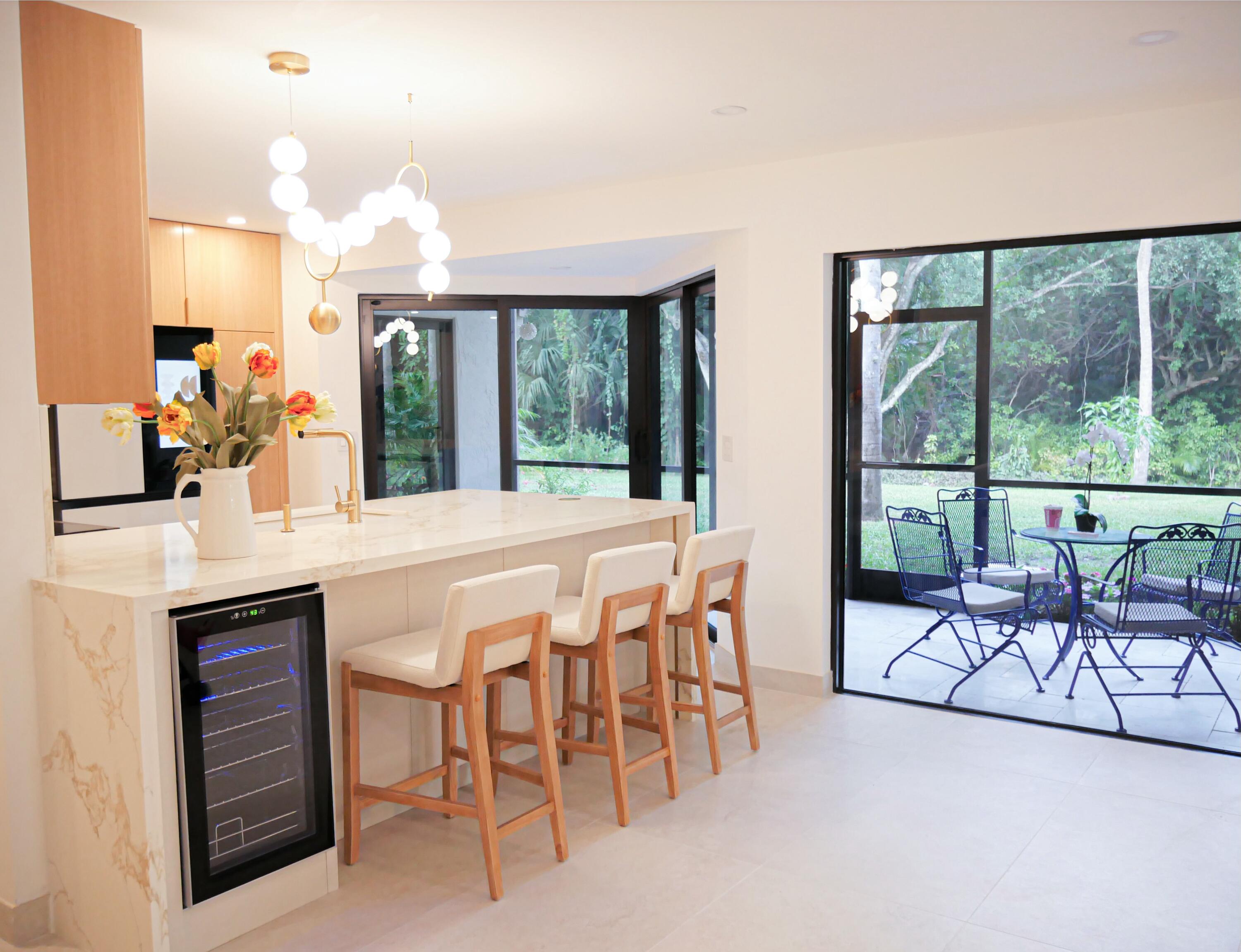 5630 Coach House Circle, Unit D Boca Raton, FL 33486 - Photo 6 of 26 a dining room with furniture and a floor to ceiling window