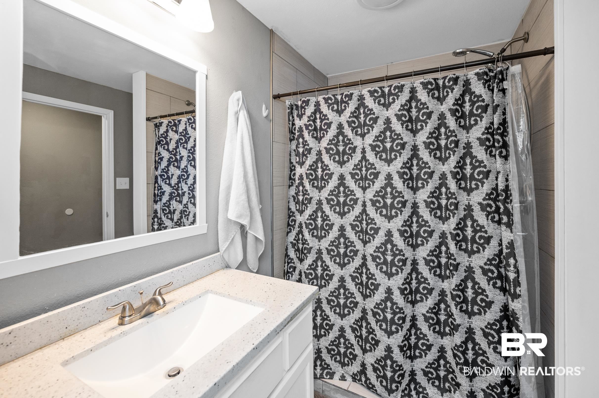 906 North Cedar Street Foley, AL 36535 - Photo 15 of 24 Bathroom featuring a shower with curtain and vanity