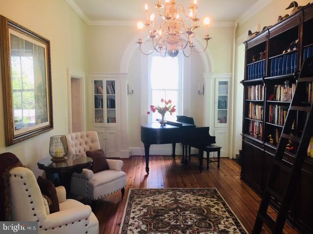 74 Waterloo Street Warrenton, VA 20186 - Photo 6 of 19 a living room with furniture a bookshelf and a window