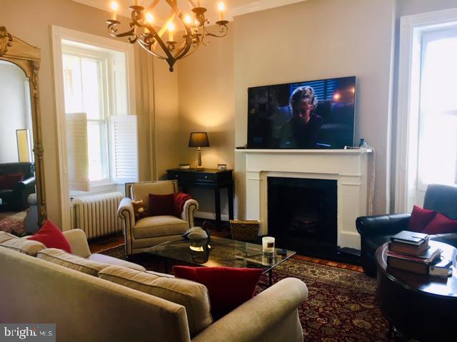 74 Waterloo Street Warrenton, VA 20186 - Photo 7 of 19 a living room with furniture a fireplace and a flat screen tv
