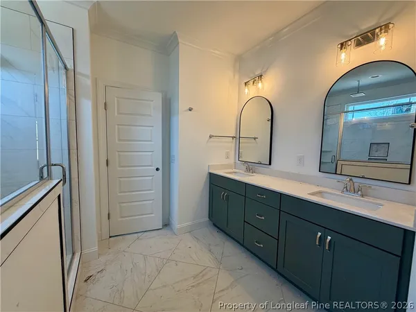 a spacious bathroom with a double vanity sink and a mirror