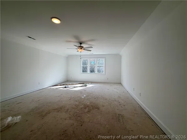 an empty room with a empty space and windows