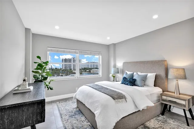 a bed room with a bed and a potted plant