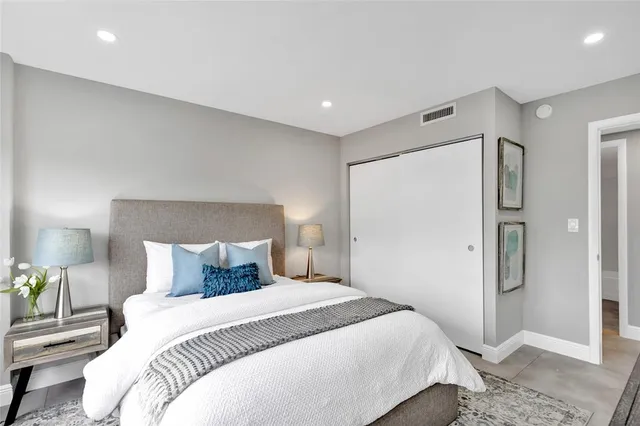 a bedroom with a bed and a walk in closet