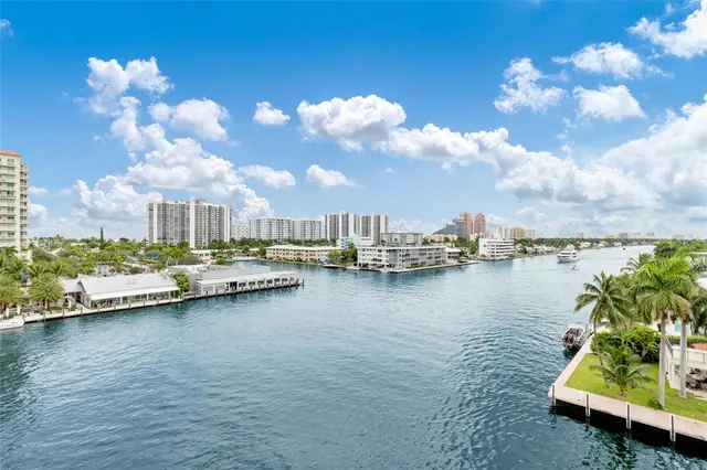 a view of a lake with boats and trees in the background