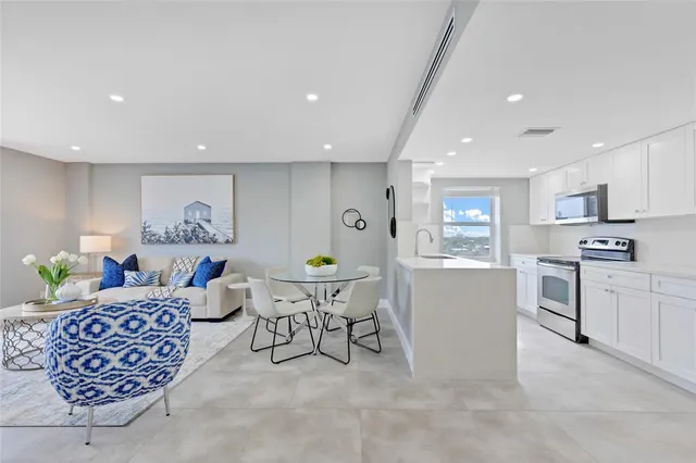 a living room with furniture a window and kitchen view
