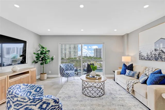 a living room with furniture and a potted plant