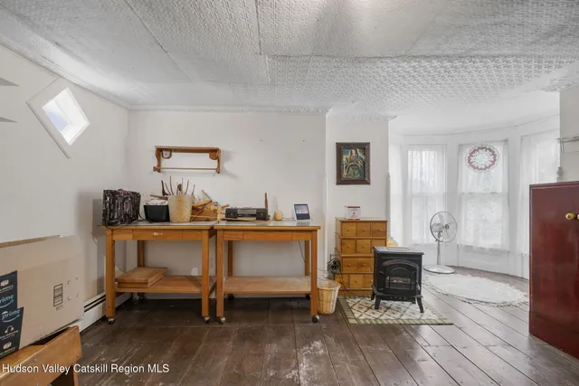 a front view of a house with a yard and fountain in middle of the green field