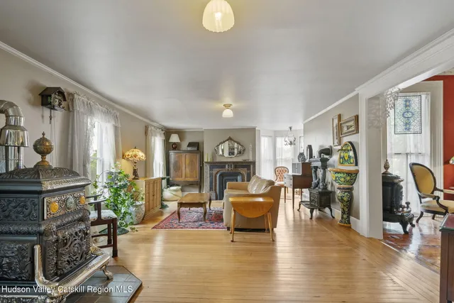 a view of a porch with chairs and table under an umbrella
