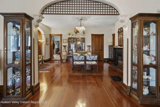 a bunch of flowers and green in front of house