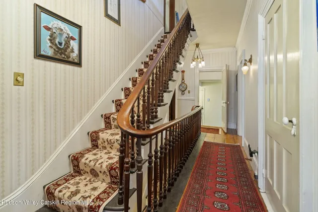 a living room with furniture a chandelier and a rug