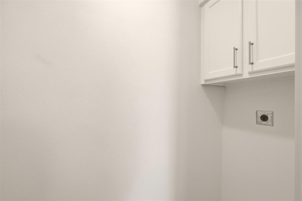 908 Isbell Road, Unit B Fort Worth, TX 76114 - Photo 13 of 27 Laundry area featuring shaker-style upper cabinetry with brushed nickel hardware and a dedicated dryer vent