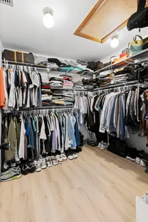 a view of walk in closet with clothes