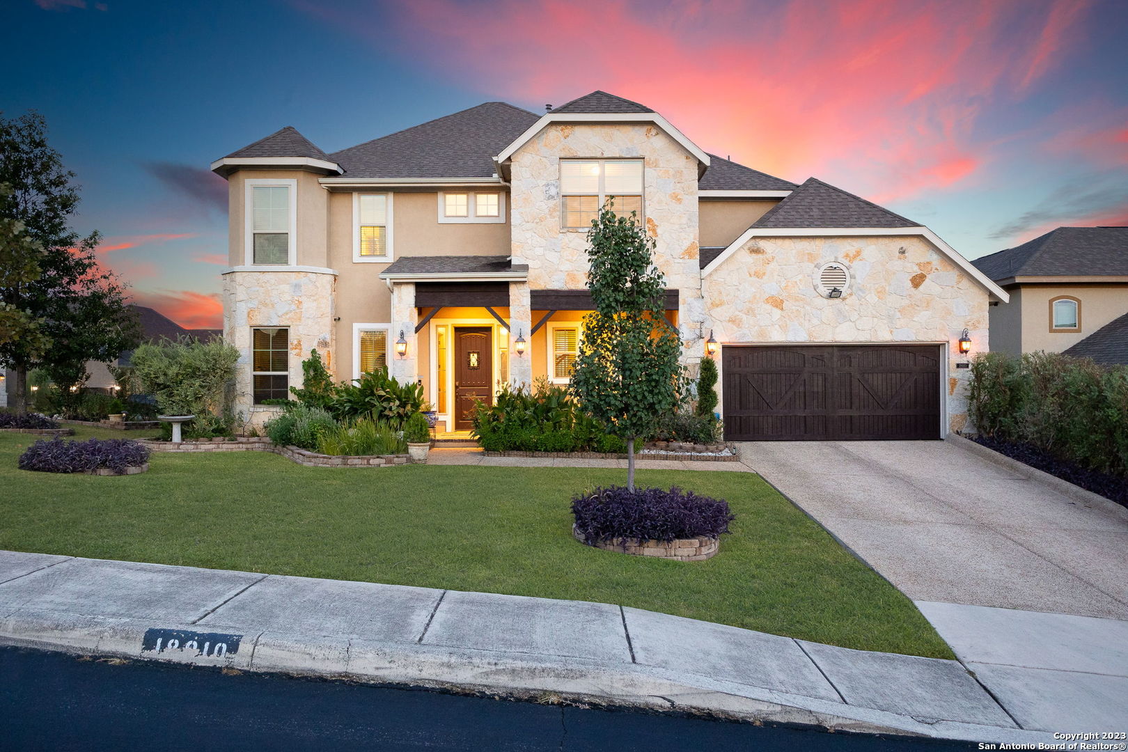 a front view of a house with a yard and garage