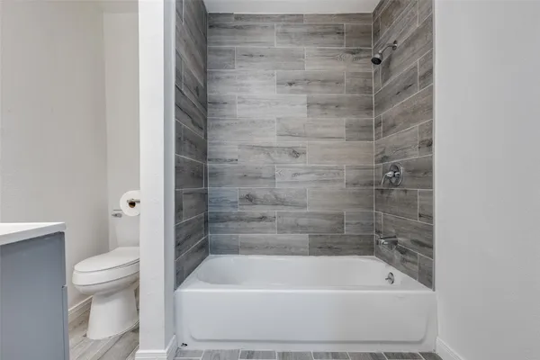 a bathroom with a shower and a toilet