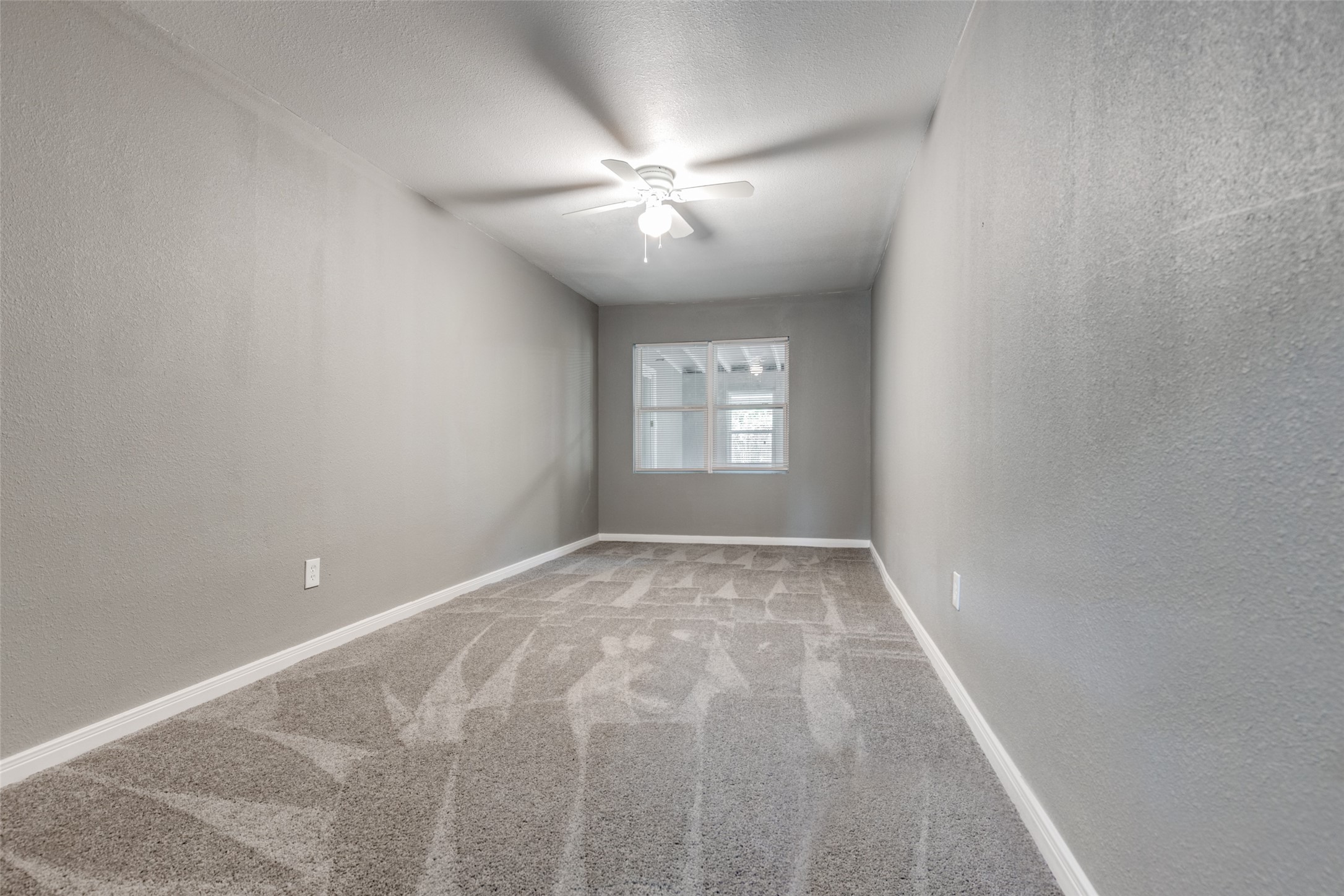 200 Pine Street Prairie View, TX 77446 - Photo 15 of 25 a view of an empty room with window and chandelier fan