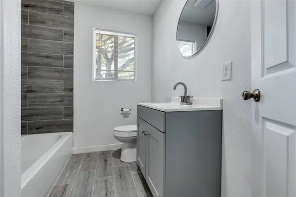 a bathroom with a sink a toilet and bathtub