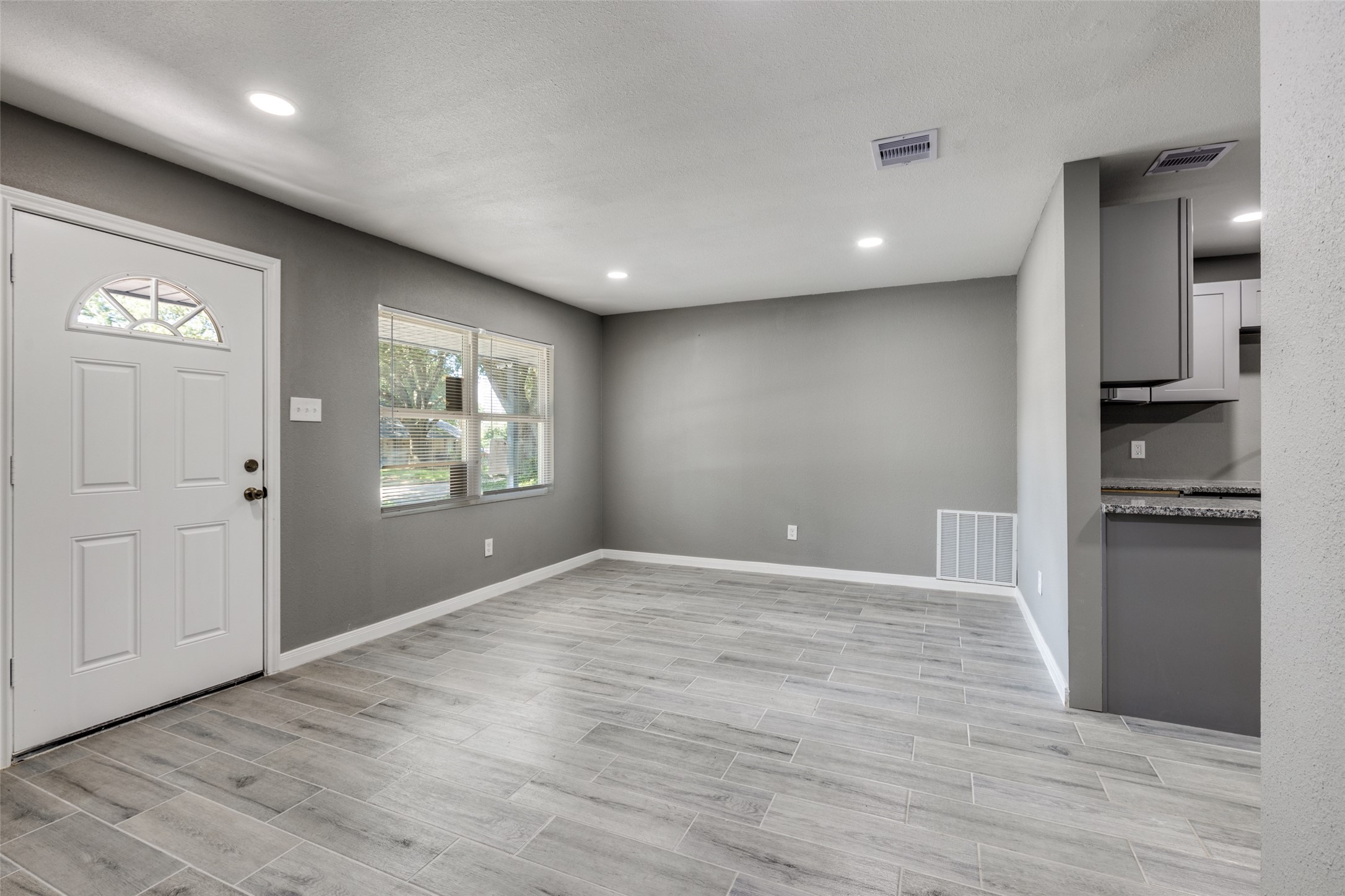 200 Pine Street Prairie View, TX 77446 - Photo 6 of 25 a view of an empty room with window and wooden floor