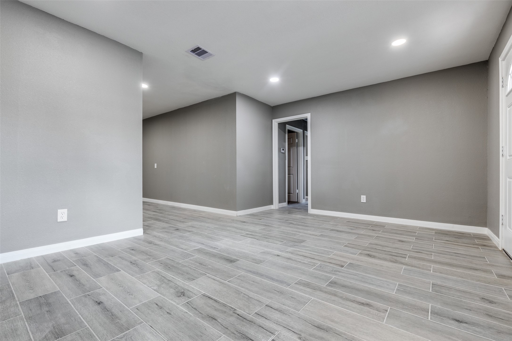 200 Pine Street Prairie View, TX 77446 - Photo 7 of 25 an empty room with wooden floor and windows