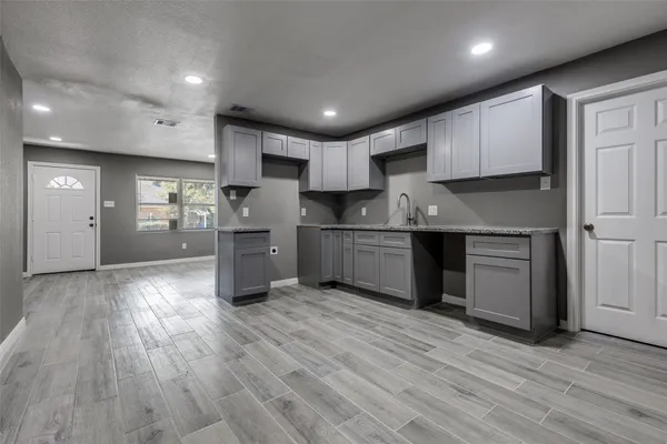 a kitchen with stainless steel appliances granite countertop a sink refrigerator and cabinets