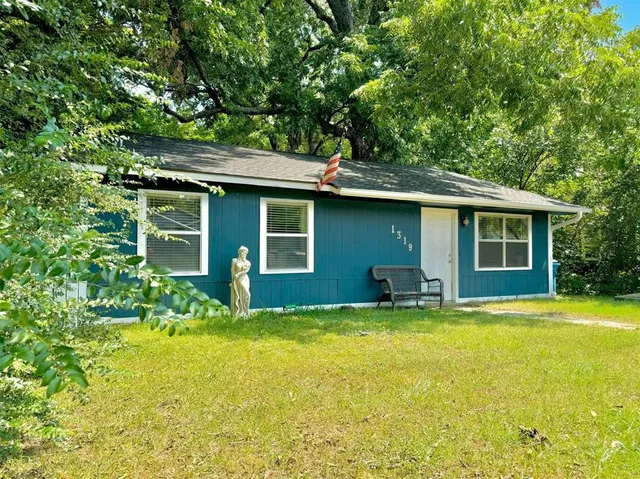 a view of a house with pool and sitting area
