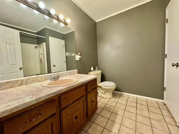 a bathroom with a granite countertop sink a toilet and a mirror