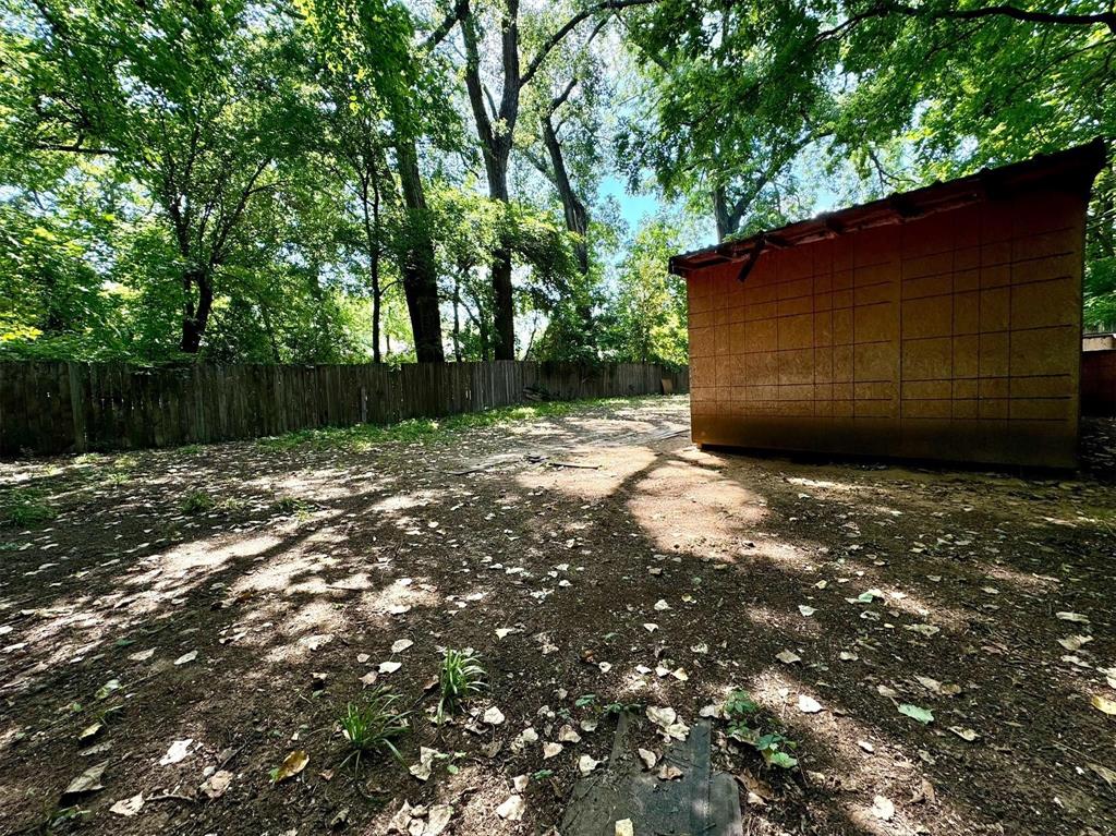 1319 West Morgan Street Denison, TX 75020 - Photo 15 of 17 a backyard of a house with lots of green space