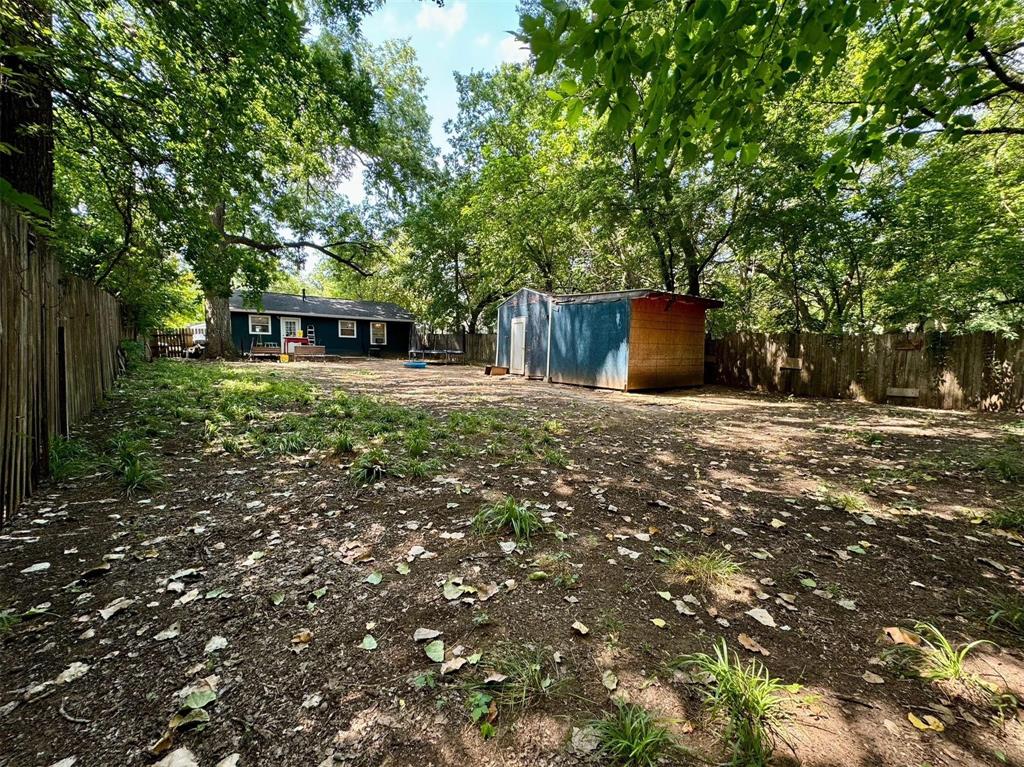 1319 West Morgan Street Denison, TX 75020 - Photo 16 of 17 a backyard of a house with lots of green space